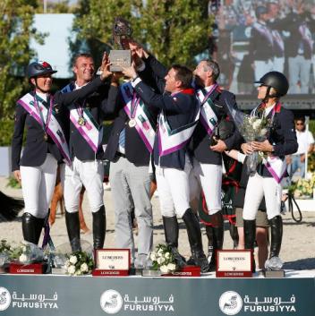 Furusiyya FEI Nations Cup™ Jumping Final 2013 - Team France (left to right) Pénélope Leprevost, Aymeric de Ponnat, Chef d'Equipe  Philippe Guerdat (partially obscured), Simon Delestre, Patrice Delaveau and Eugenie Angot celebrating victory in the world's richest team event, the Furusiyya FEI Nations Cup™ Jumping Final in Barcelona. Credit: FEI/Tomas Holcbecher 